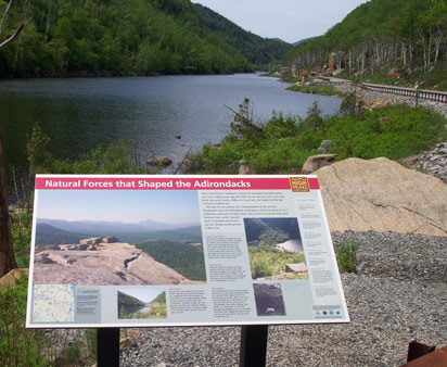 Interpretive exhibit overlooking Cascade Lake near Pitchoff Mountain.